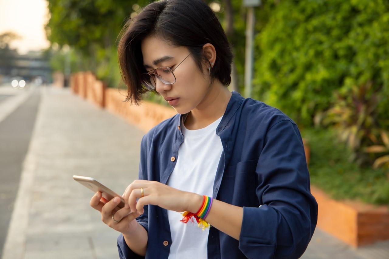 Young adult looks down at phone